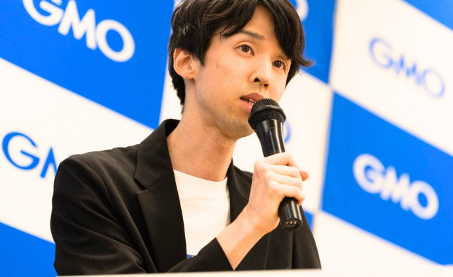 Takuya Kawai speaking at GMO